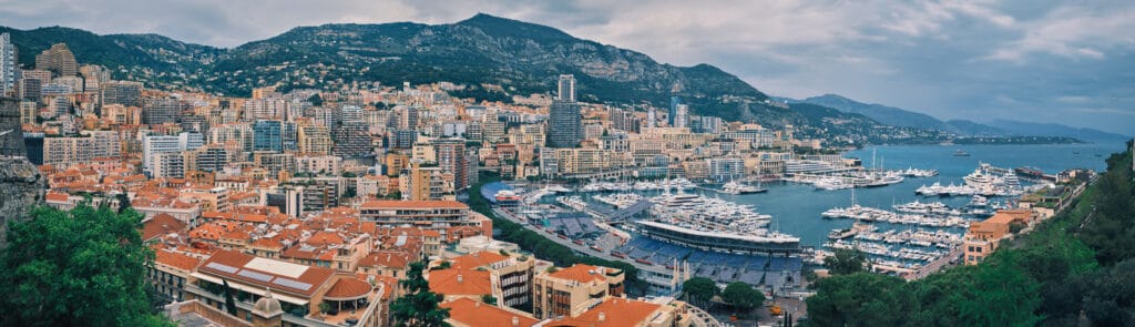 Panorama of Monte Carlo, Monaco with Formula one race track street circuit and port with yachts and boats